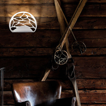 Italian designer Kelly wall light by Andrea Tosetto featuring dimmable 3000K LED and decorative cut-out pattern