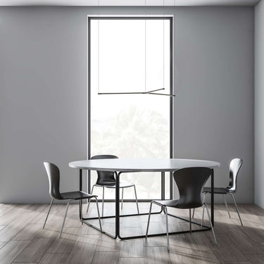 Minimalist Y-shape LED pendant lamp by Koncept Tech hanging above dining table.