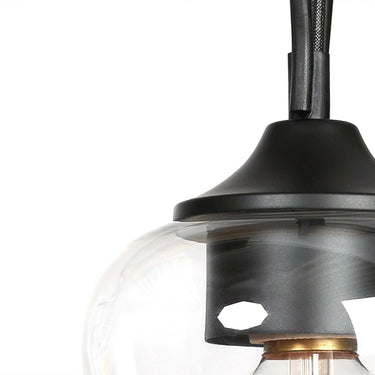 matte black Kyanides linear island chandelier with clear goblet-style glass shades over kitchen island