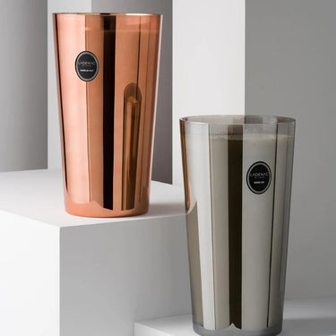 A hand lighting the Ladenac Urban Senses Luxury Candle - 8500g Jar, releasing its captivating fragrance