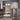 ET2 Larmes clear glass teardrop pendant hanging beside kitchen cabinets and a stainless refrigerator