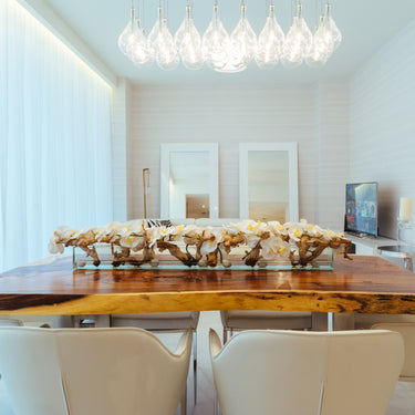 ET2 Larmes LED clear teardrop glass pendant cluster over a live-edge dining table in a bright white room