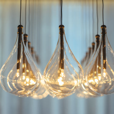 ET2 Larmes LED clear teardrop glass shades close-up with warm glowing lamps