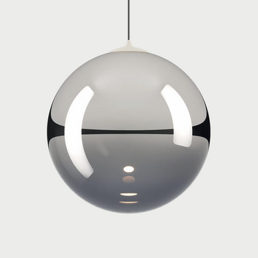 Lodes Random Solo pendant light illuminating a modern living room with a soft, warm glow