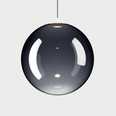 Lodes Random Solo suspension light installed over a dining table, providing focused illumination
