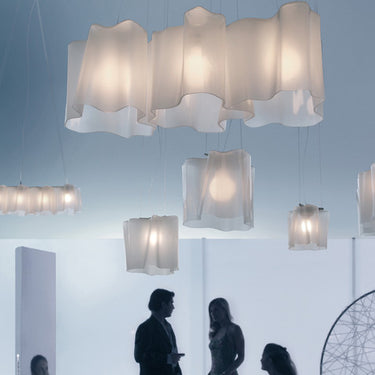 Handblown glass triple linear pendant light by Artemide for modern home and office design