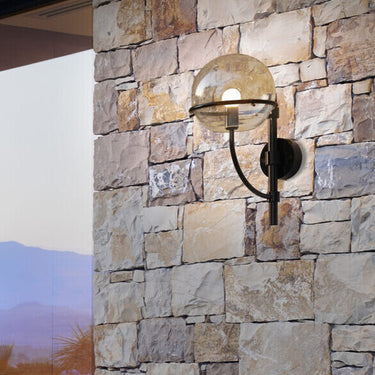 Lyndon 161 mini outdoor wall lamp by Oluce mounted on a stone wall, lifestyle view