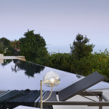 Lyndon 283 outdoor table lamp by Oluce on an outdoor table, lifestyle view