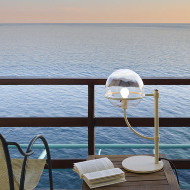 Lyndon 283 outdoor table lamp by Oluce on a poolside table, lifestyle view