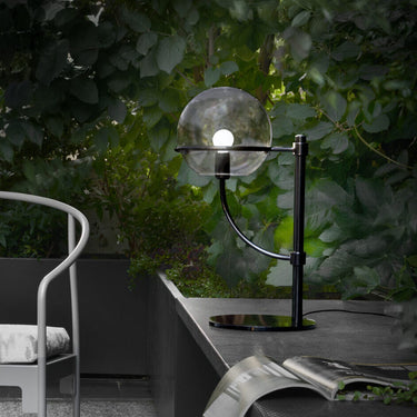 Lyndon 283 outdoor table lamp by Oluce on a balcony table, lifestyle view