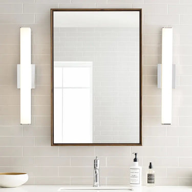 24in chrome contemporary bath fixture with even LED illumination, residential use installed beside the bathroom mirror.