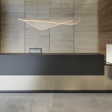 ET2 Manta large linear pendant hung above a black reception desk in a lobby with wood slat walls