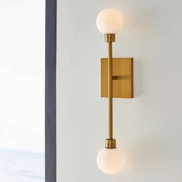 Mara Wall Sconce by Visual Comfort with Dual Glass Globes in Aged Brass Finish for Commercial Bathrooms