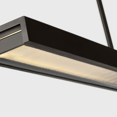 Sculptural 48" linear chandelier with a textured glass shade that mimics frozen water