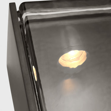 Maybeck 18 textured glass outdoor sconce after dark on a terrace