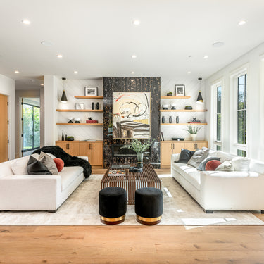 ET2 Mermaid black cone pendants in a wide open living room with white sofas, black ottomans and an oak floor