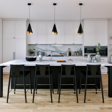 ET2 Mermaid black and gold cone pendants in a row over a white kitchen island with black bar stools