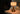 Mini Tito Cordless Table Lamp Dark Antique Brass Pleated Shade on desk