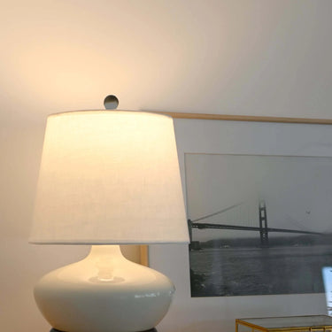 Portable LED table lamp with ivory ceramic body and black accents