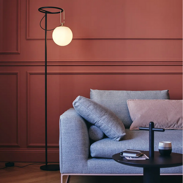 Contemporary Artemide NH floor lamp with white blown glass diffuser and sleek black base for luxury interiors