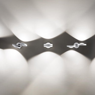 Chrome Nautilus Wall Sconce by Lodes featuring convex lens for precise LED light projection in modern interiors