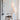 Two white Nest pendants hanging together beside a wooden chair and shelving