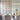 ET2 Newton clear apple glass pendants with brass fonts over a dining table in a room with slatted wood wall