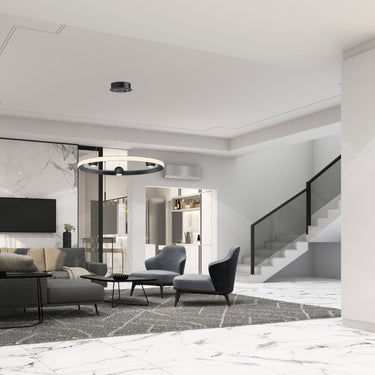 ET2 Nodes ring pendant hanging over a gray sofa in a modern living room beside a staircase