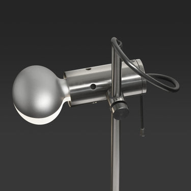 Detail of the Agnoli table lamp in satin black nickel on a dark background