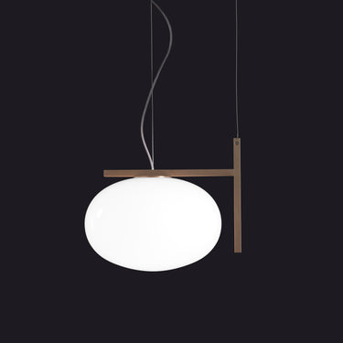 Oluce Alba 466 pendant light in anodic bronze with a blown glass sphere on a dark studio background