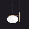 Oluce Alba 466 pendant light in satin brass with a blown glass sphere on a studio background