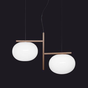 Oluce Alba 468 pendant light in anodic bronze with two blown glass spheres on a studio background