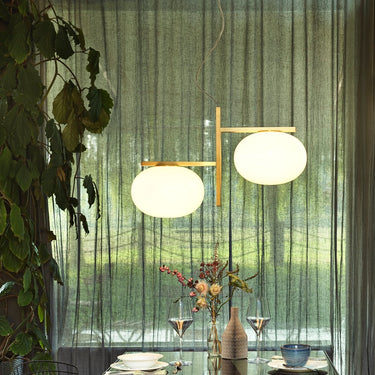 Oluce Alba 468 pendant light with two glass spheres in front of curtains