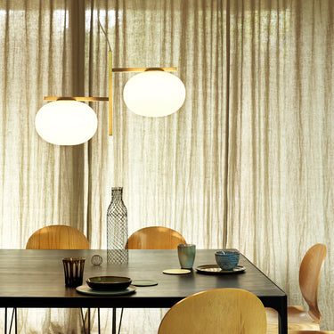 Close view of the Oluce Alba 468 pendant glass spheres beside curtains