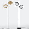 Oluce Berlin floor lamps in anodized brass and matt black on a light studio background