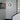 Oluce Berlin-Out round wall lamp on a white wall by a staircase