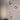 Oluce Berlin-Out small round wall lamp on a textured white wall
