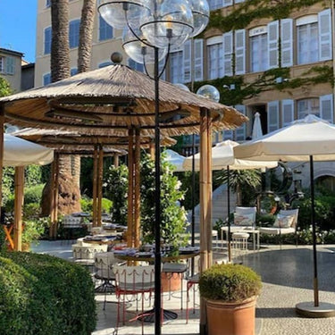Lyndon outdoor floor lamp by Oluce on a patio under a pergola, lifestyle view