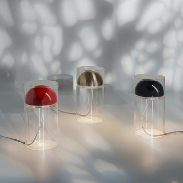 Oluce Medusa table lamps in black casting soft shadows