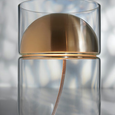 Close view of the satin gold metal dome of the Oluce Medusa table lamp