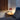 Red Oluce Medusa table lamp on a bedside table
