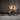 Oluce Superluna floor lamp lighting a seating area with armchairs