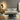 Oluce Superluna floor lamp beside a sofa and coffee table