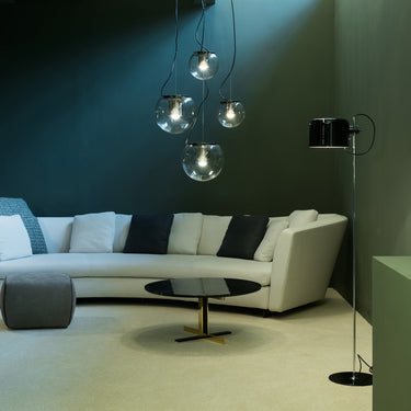 Oluce The Globe pendants hanging above a coffee table in a living room