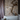 Oluce The Globe pendants hanging beside a bathtub and marble wall