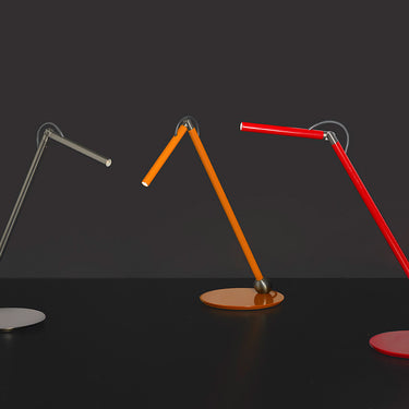 Oluce Calamaio desk lamps in satin black nickel, mustard yellow and scarlet red, studio view