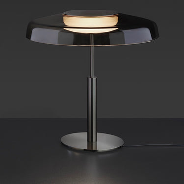 Oluce Dora table lamp with smokey grey glass shade, lit