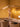 Ilo horizontal LED pendant lighting a dining table in a warm ochre room with dried flowers