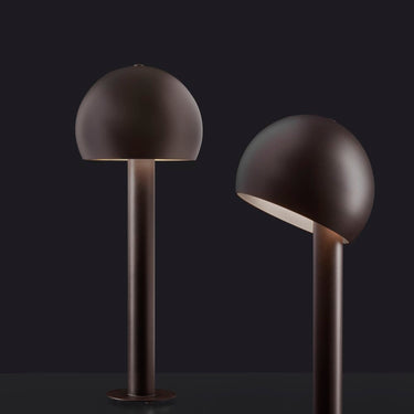 Two Oluce Otto outdoor lamps, one with the dome head tilted to show the adjustable light opening