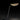 Oluce Plume table lamp by Christophe Pillet glowing against a dark background
